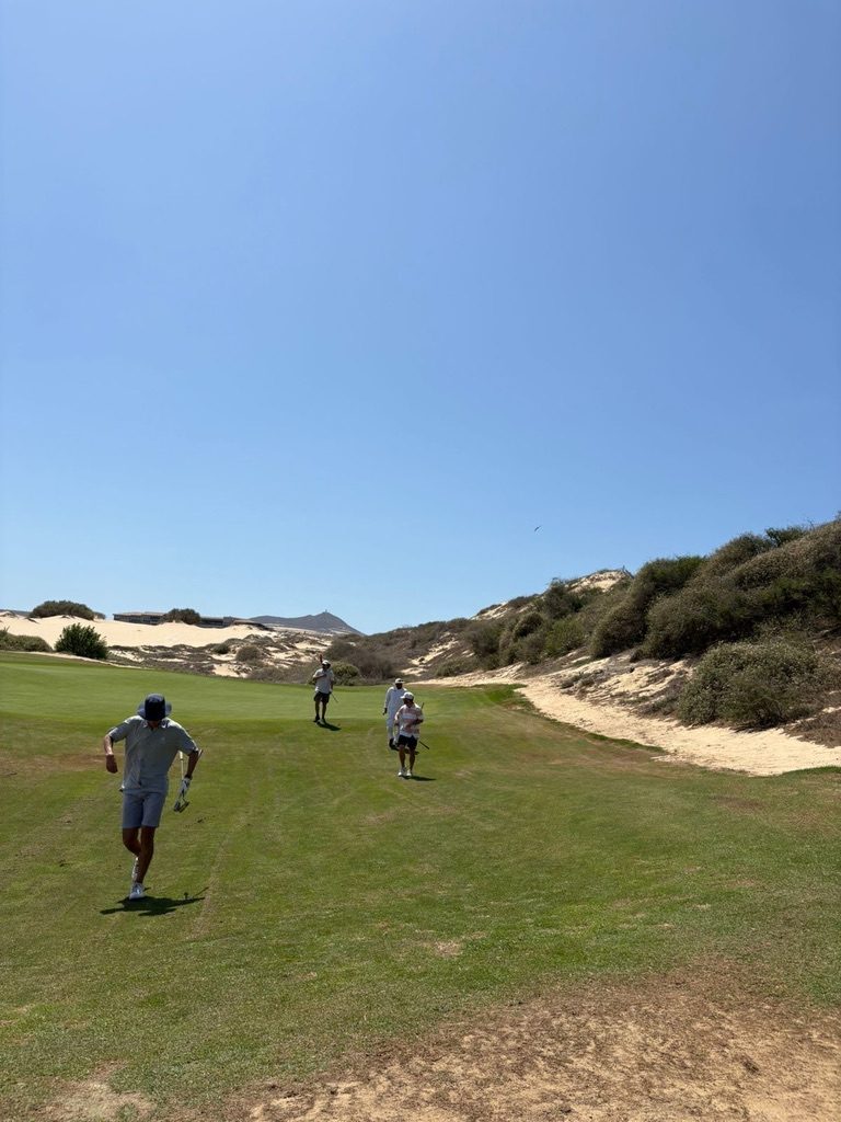 Group of golfers walking a Diamante Dunes fairway