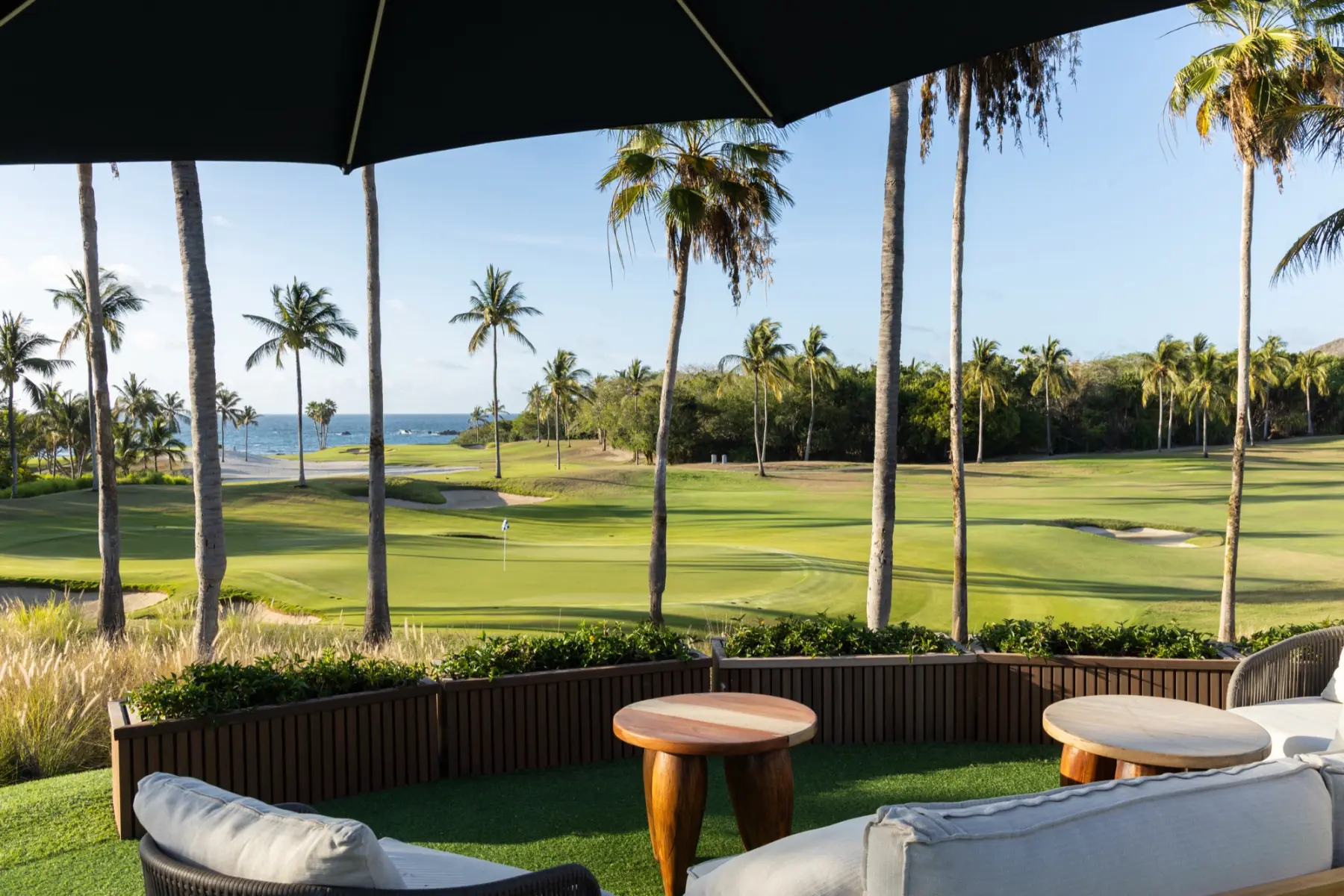 A shaded clubhouse terrace at Punta Mita looking out over the course.